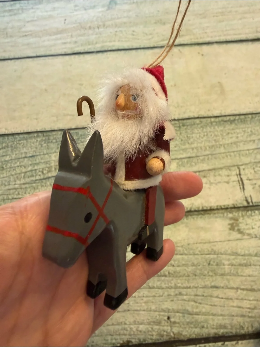 Vintage Christmas wood Santa riding a donkey horse ornament.